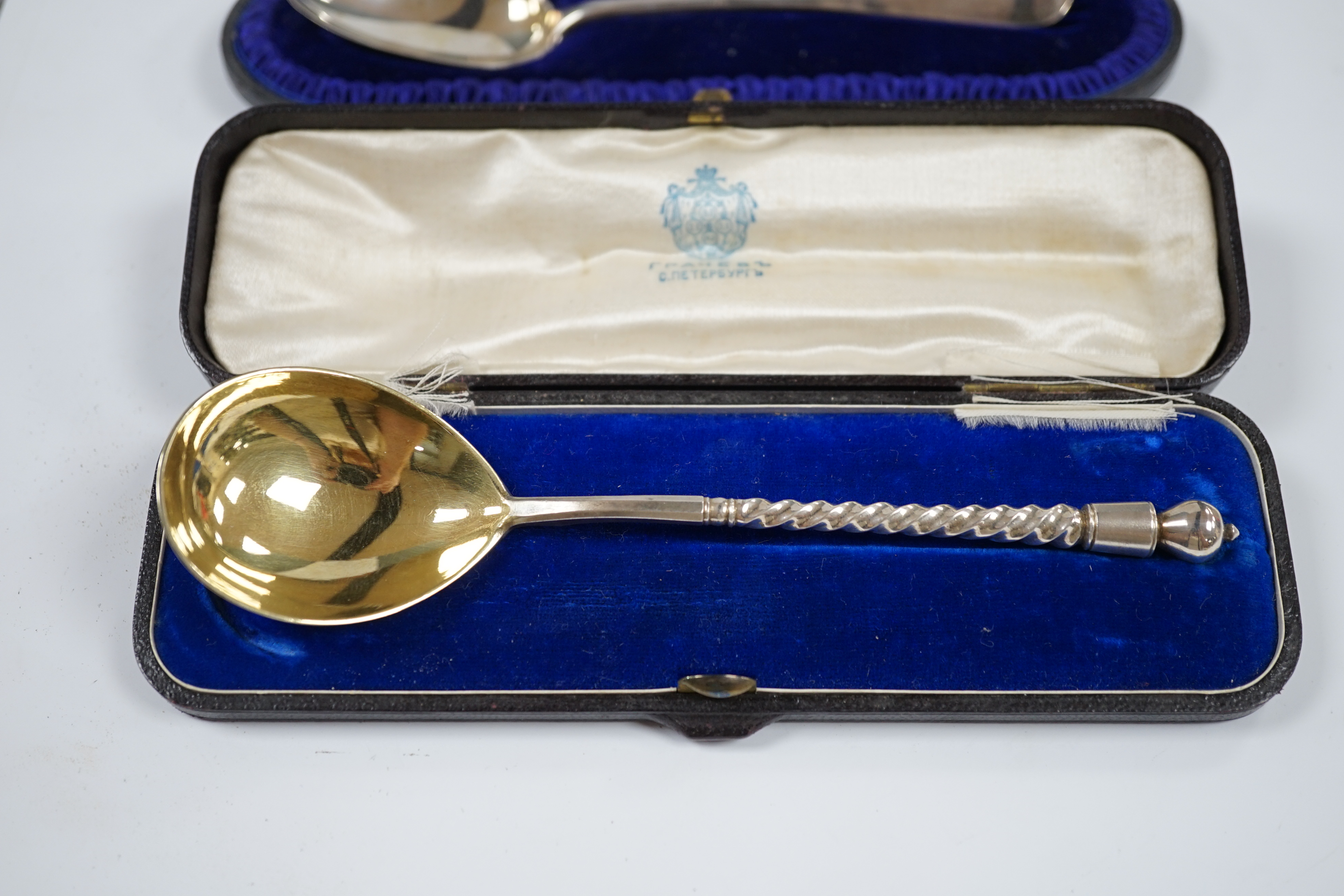 A cased Russian 84 zolotnik spoon, 16.8cm and a cased Victorian silver dessert spoon, London, 1893. Condition - fair to good